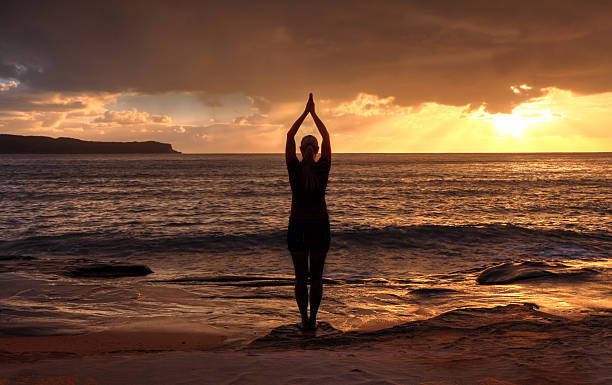 Tadasana (Mountain Pose) at sunrise—grounding practice for stress relief- myhealthlogy.com